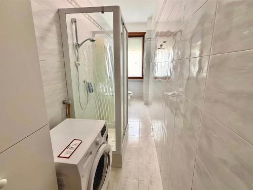 a washing machine in a bathroom with a shower at Chez Louise, free wi-fi & 5 minutes from InalpiArena in Turin