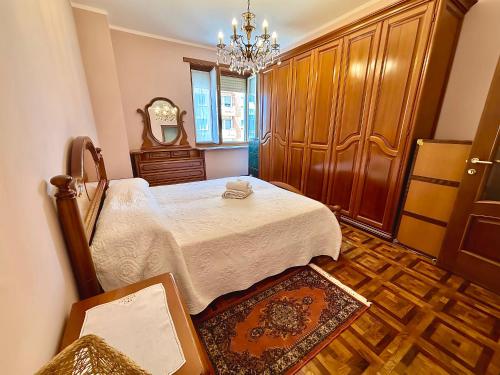 a bedroom with a bed and a chandelier at Chez Louise, free wi-fi & 5 minutes from InalpiArena in Turin