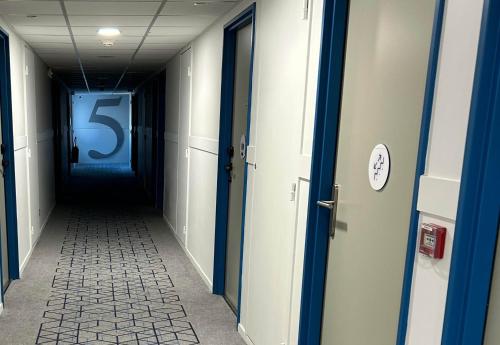 a long hallway with a large number on the wall at B&B HOTEL Le Havre Centre in Le Havre