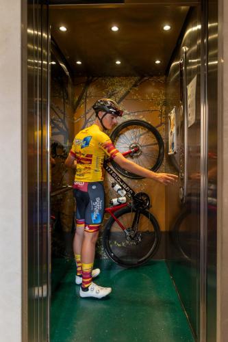 a man is putting a bike on a wall at Grand Hotel Forlì in Forlì