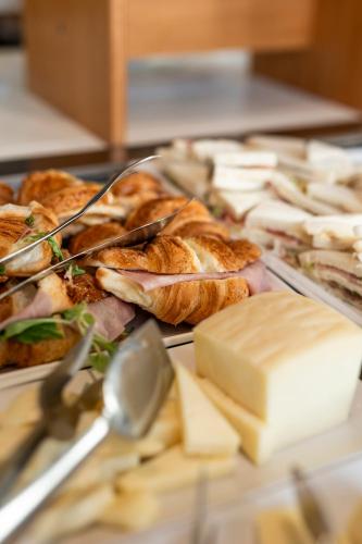 a table topped with lots of different types of food at Grand Hotel Forlì in Forlì