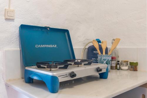 a blue and white stove sitting on top of a counter at Off-Grid - Puerto Mika in Órgiva