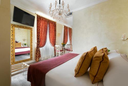 a bedroom with a large bed and a chandelier at Relais Empire in Verona