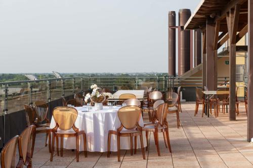 a table and chairs on the roof of a building at Grand Hotel Forlì in Forlì