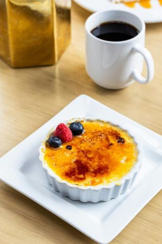 a dessert with berries and a cup of coffee at Sheraton Suites Chicago O'Hare in Rosemont