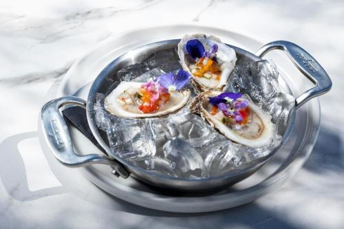 three oysters in a tea pot on a table at JW Marriott Savannah Plant Riverside District in Savannah