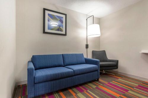 a living room with a blue couch and a chair at Holiday Inn Express & Suites Chicago West - St Charles by IHG in Saint Charles