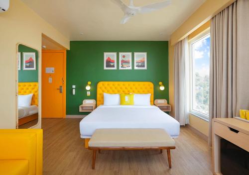 a bedroom with a large bed and green walls at Bloom Boutique - Rishikesh Hills in Rishīkesh