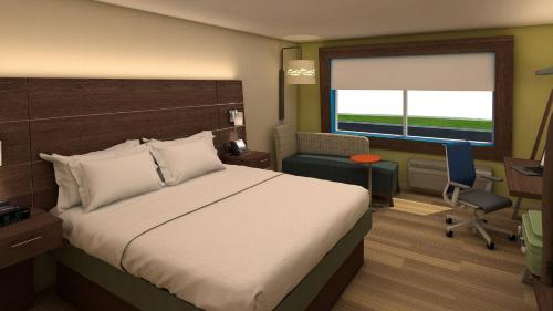a bedroom with a bed and a desk and a chair at Holiday Inn Express & Suites Chicago West - St Charles by IHG in Saint Charles
