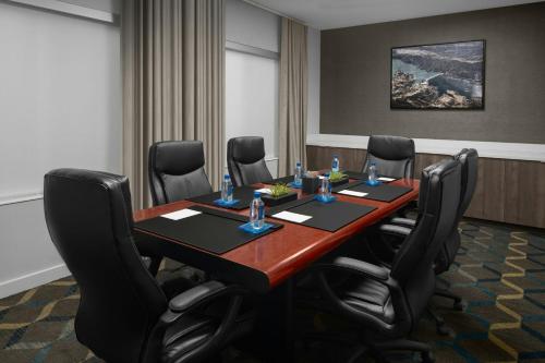 a conference room with a wooden table and black chairs at Fairfield Inn by Marriott Santa Clarita Valencia in Santa Clarita