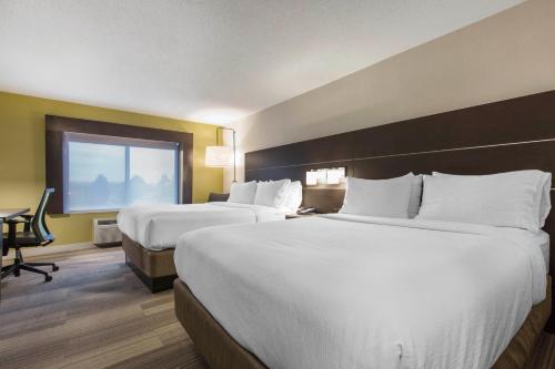 a hotel room with two beds and a window at Holiday Inn Express & Suites Chicago West - St Charles by IHG in Saint Charles