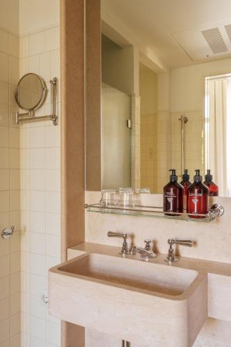 a bathroom with a sink and a mirror at Stockholm Stadshotell in Stockholm