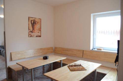a room with two tables and a window at Hotel Isenbütteler Hof in Isenbüttel