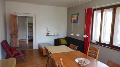 a living room with a table and a couch at Holiday House Malá Skála in Malá Skála