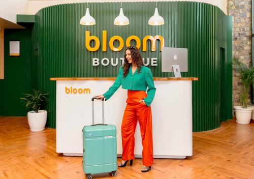 a woman standing in front of a counter with a suitcase at Bloom Boutique - Rishikesh Hills in Rishīkesh