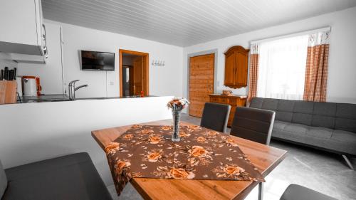 a living room with a table with flowers on it at Huberbauer in Johnsbach