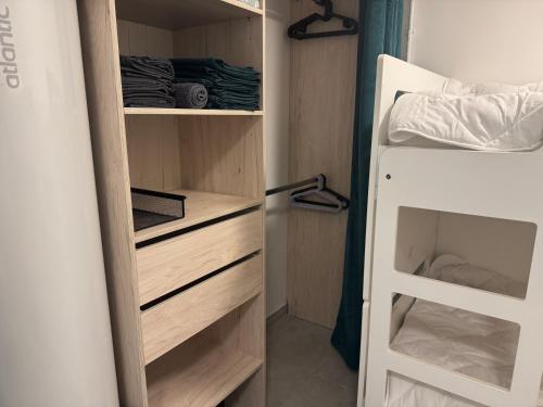 a closet with wooden drawers and a bunk bed at Apt 4 people pool air conditioning garden in Mandelieu-la-Napoule