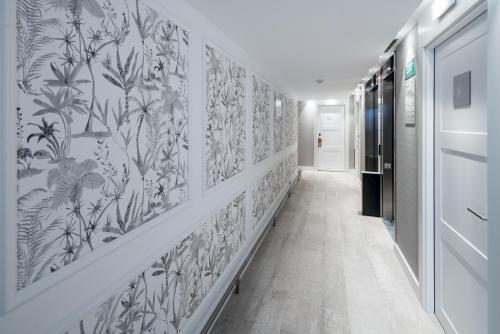 a hallway with black and white wallpaper on the walls at Catalonia Magdalenes in Barcelona