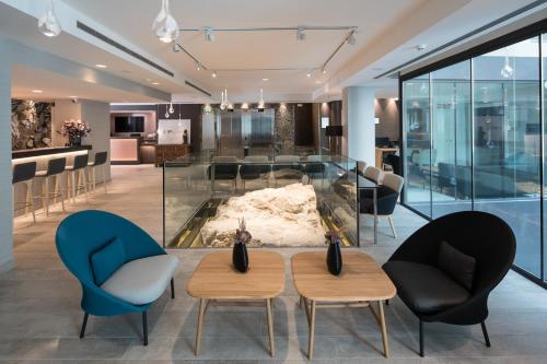 a lobby with two chairs and a fire place at Catalonia Magdalenes in Barcelona
