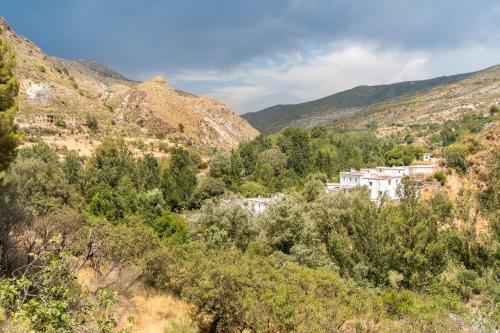 a village in the middle of a mountain at Off-Grid - Puerto Mika in Órgiva