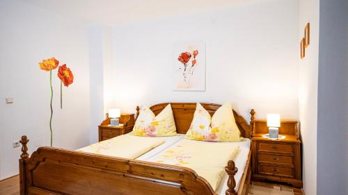 a bedroom with a wooden bed with two night stands at Huberbauer in Johnsbach
