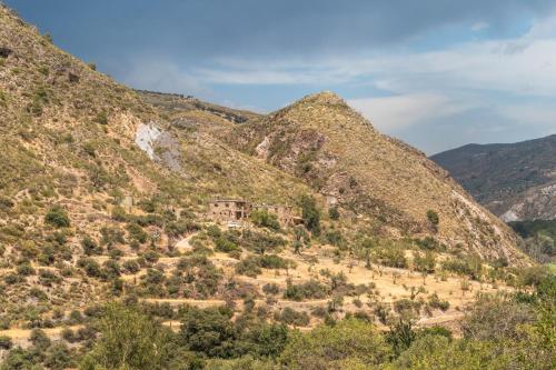 a house on the side of a mountain at Off-Grid - Puerto Mika in Órgiva