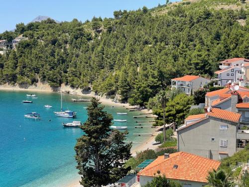a view of a beach with boats in the water at Apartments Domani in Omiš