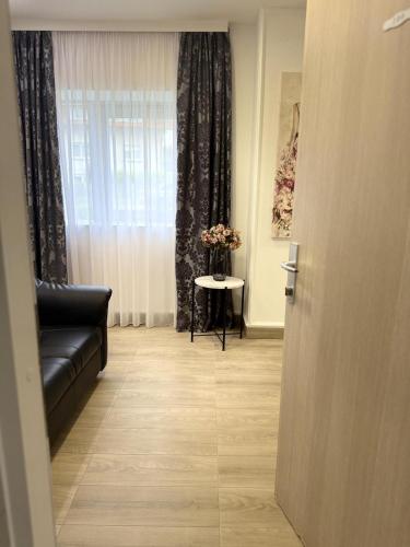 a room with a couch and a table and a window at Alsago Lux in Sesvete