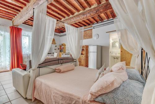 a bedroom with a bed with white curtains at Nido d'amore in Portoferraio