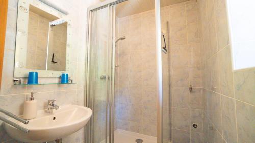 a bathroom with a shower and a sink at Huberbauer in Johnsbach