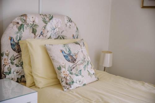 a bed with a chair with a pillow on it at Leygreen Farmhouse B&B in Beaulieu