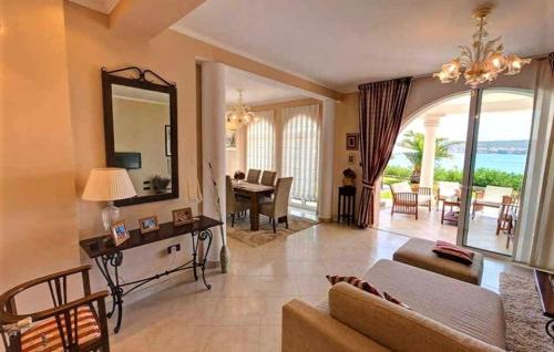 a living room with a couch and a mirror at Villa Palace Clara Apartment 5 island Krk by Vill in Malinska
