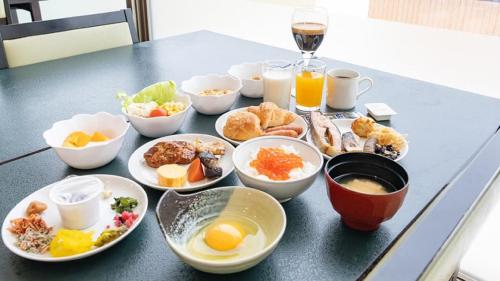 a table with a bunch of breakfast foods and drinks at LiVEMAX RESORT Shiretoko Sea Front in Rausu