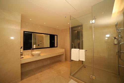 a bathroom with a sink and a glass shower at Crowne Plaza Pune City Centre by IHG in Pune