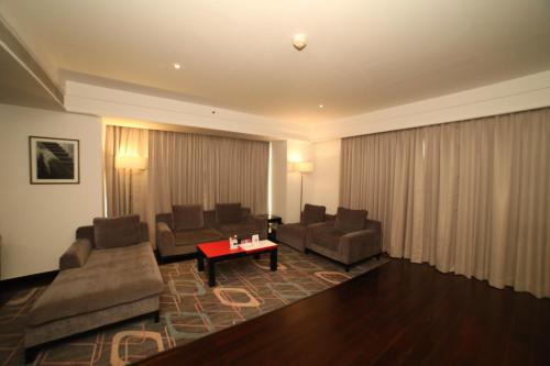 a living room with two couches and a table at Crowne Plaza Pune City Centre by IHG in Pune
