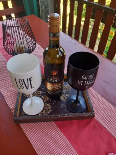 a bottle of wine and two cups on a table at Kuća za odmor ,,BREZA,, 