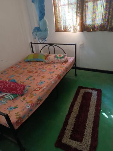 a bed in a room with a green floor at Local Life House in Dambulla