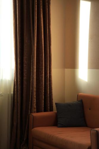 a living room with a couch and a window at Dilijan Park Resort & Villas in Dilijan