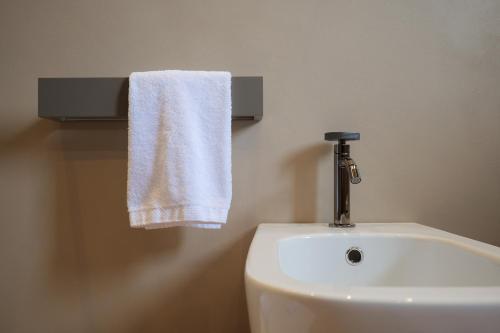 a white towel hanging over a sink in a bathroom at Villa Amelia in Orta San Giulio