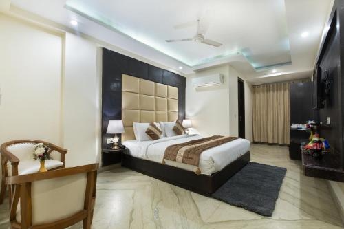 a bedroom with a large bed and a ceiling at VIVVA Premier Delhi Aerocity FREE Airport Pick Up in New Delhi