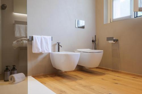 a bathroom with a white toilet and a sink at Villa Amelia in Orta San Giulio