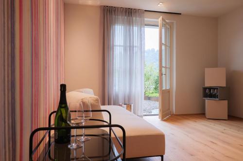 a hotel room with a bed and a bottle of wine at Villa Amelia in Orta San Giulio
