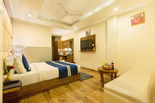 a hotel room with a bed and a tv at VIVVA Premier Delhi Aerocity FREE Airport Pick Up in New Delhi