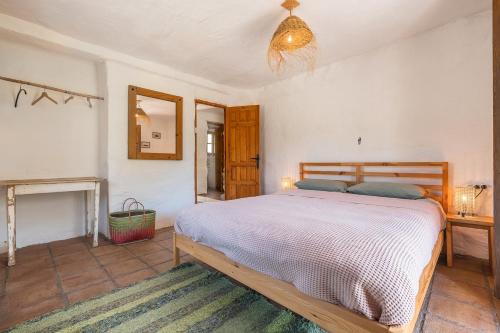 a bedroom with a large bed and a fireplace at Off-Grid - Puerto Mika in Órgiva