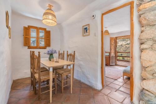 a dining room with a table and chairs at Off-Grid - Puerto Mika in Órgiva
