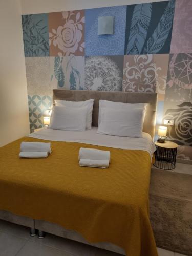 a large bed with two towels on top of it at Apartman Ulrich in Lukovo