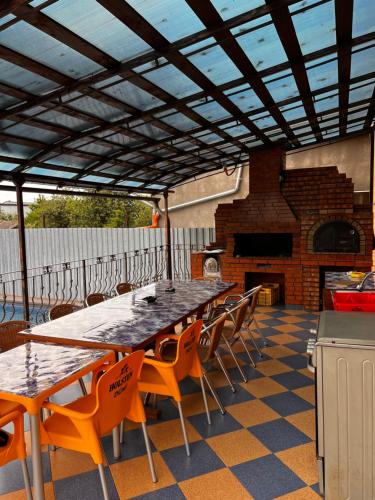 a patio with a table and chairs and a fireplace at Vila Ovi Salin in Turda