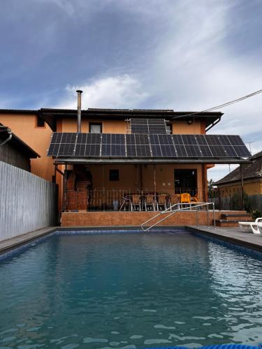 a house with a swimming pool with solar panels at Vila Ovi Salin in Turda
