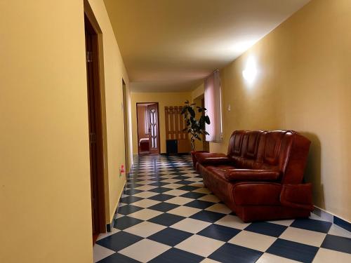 a living room with a couch and a checkered floor at Vila Ovi Salin in Turda