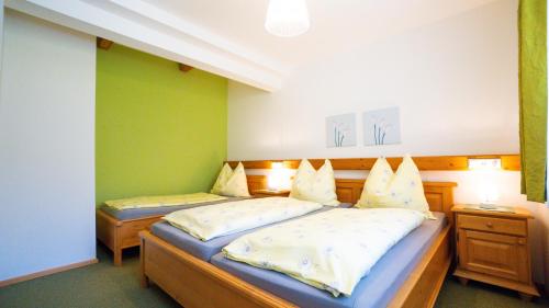 a bedroom with two beds and two night stands at Huberbauer in Johnsbach